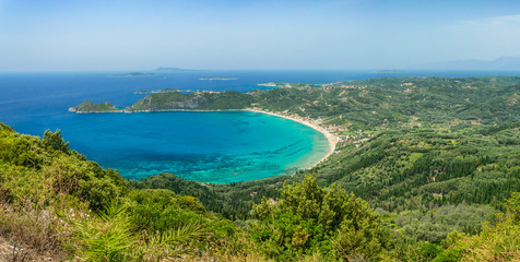 Stretching panorama from the road to Angelokastro, View of the bay of Agios Georgios Pagon and the azure sea.