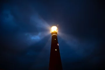 Fotobehang lighthouse at night © Olha Rohulya
