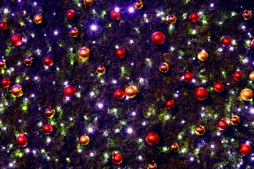 Obraz na płótnie Canvas Christmas and New Year winter holidays idyllic festive background decorated needle branches by colorful balls and garland lights