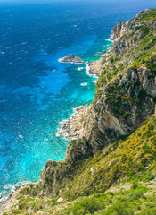 Fototapeta na wymiar Angelokastro, a rocky mountain slope on the shores of the blue sea.