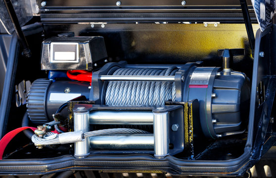 A powerful electric winch is located in the cargo compartment of an equipped fire truck.