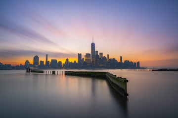 Long exposure at sunrise from Jersey City of Lower Manhattan  - obrazy, fototapety, plakaty