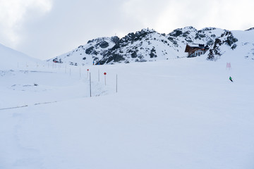 Fototapeta na wymiar ski slope with a wooden hut