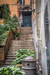 Fototapeta na wymiar A beautiful Roman courtyard on Coronari street. Selective focus. Rome, Lazio, Italy