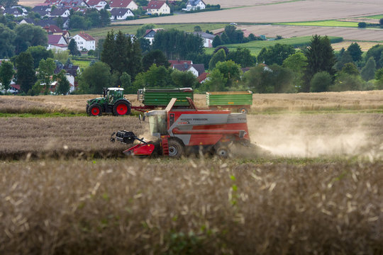 NEUSTADT, GERMANY - JULY 30, 2017: Harvesting on the fields in the suburbs of the small town of Neustadt (Marburg-Biedenkopf district in Hessen). Harvester on the field.