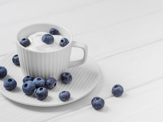 Blueberries in sour cream on white wooden table