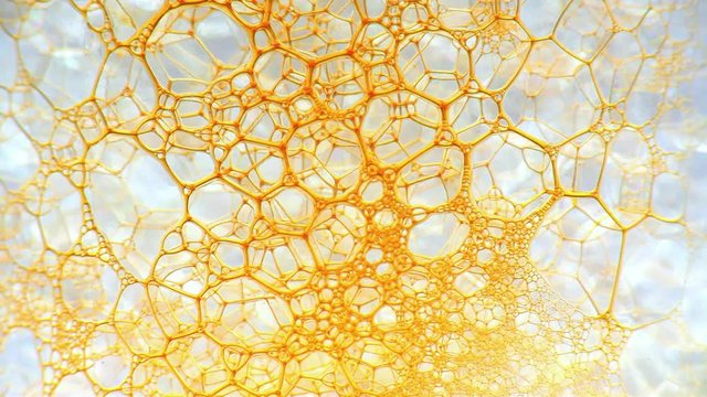 Colorful soap foam with popping bubbles background. Ink filling a mass of bubbles formed in liquid. Abstract biological structure. Unusual wallpaper. Huge batch of puffy, fascinating soap foam pattern