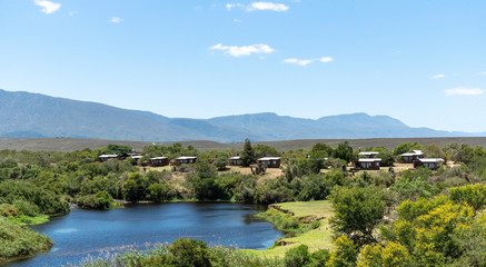 Fototapeta na wymiar Swellendam, Western Cape, South Africa, December 2019. Campsite on the Breede River viewd from Aloe Hill on the Garden Route.