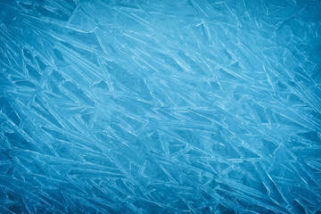 Obraz premium Background of blue cold winter ice. Texture of frozen surface. Frost pattern