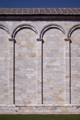 Antique vertical wall. Medieval marble stone wall with arcs. Classical wall with columns and arches. Architectural decoration background.