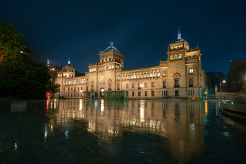 Fototapeta na wymiar Valladolid, Spain. View of Zorrilla square at dusk with building of Cavalry Academy reflecting in water