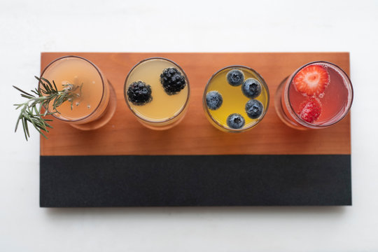 Top View Of A Cocktail Flight Board With Champagne And Fresh Fruit