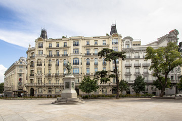 Plaza de las Cortes with statue of Miguel de Cervantes and to the building Plus Ultra Seguros, Madrid, Spain