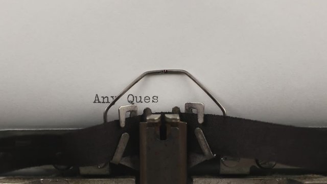 typing a quote any questions, old vintage typewriter with a sheet of paper