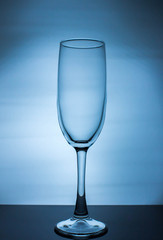 empty transparent wine glass on a blue background