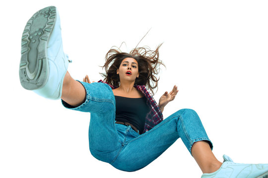 A second before falling. Caucasian young girl falling down in moment with bright emotions and facial expression. Female model in casual clothes. Shocked, scared, screaming. Copyspace for ad.