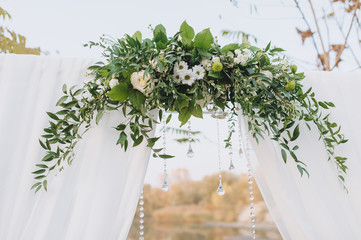 Wedding decorations of the arch close-up at the ceremony of various flowers and foliage. Wedding...