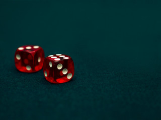 two red dices on green casino table