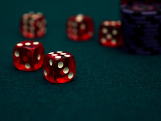 red dices on green casino table