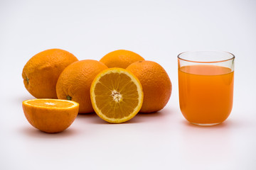 Orange juice in a glass with fresh orange fruits isolated on white Background