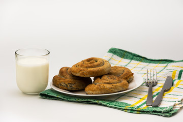 Domestic Home made Rolled pastry with spinach and cheese on a napkin with a glass of Yogurt