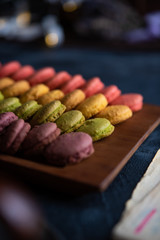 Colorful french macarons on dark table