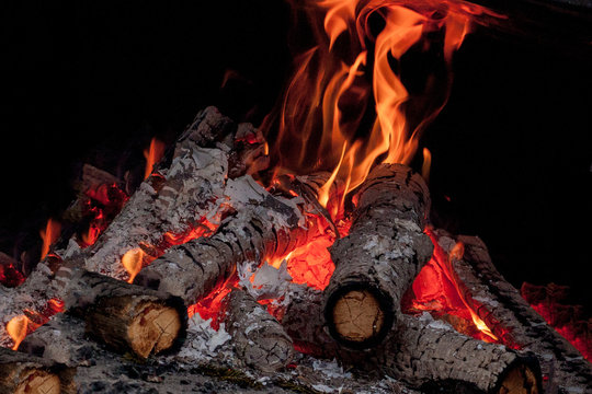 Hot Vivid Burning Birch Logs In Fireplace On A Cold Winter Day