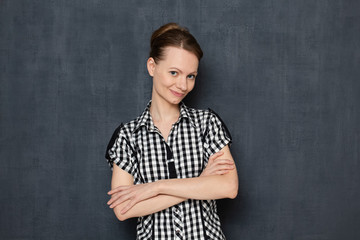 Portrait of friendly girl smiling and holding arms crossed on chest