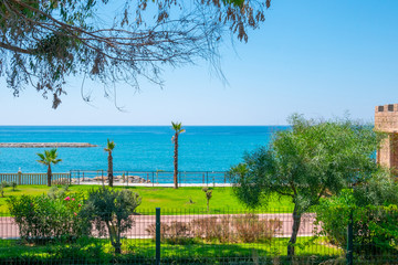 Fototapeta na wymiar Closed private property of the sea coast. Fence passage to a beautiful beach. Picturesque seascape view on Mediterranean Sea