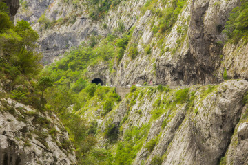 Views of road trough tunnels, canyons, mountains and forests in the Durmitor nature park, Montenegro