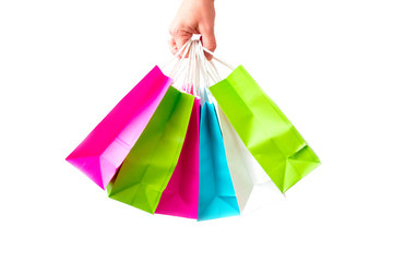 Many packages with purchases are isolated on a white background. A bunch of colored shopping bags is in the hand. Concept of children's shopping, discounts and sale.