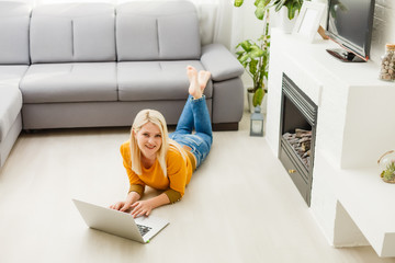 woman sitting on sofa with laptop