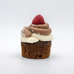 chocolate cupcake with frosting and raspberry garnish