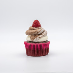 chocolate cupcake with frosting and raspberry garnish