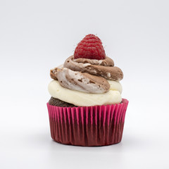 chocolate cupcake with frosting and raspberry garnish