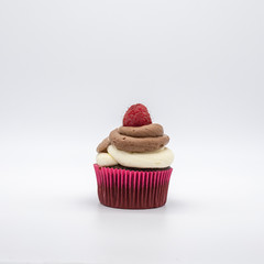 chocolate cupcake with frosting and raspberry garnish