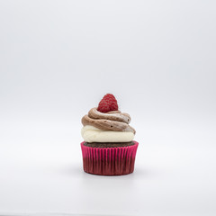 chocolate cupcake with frosting and raspberry garnish