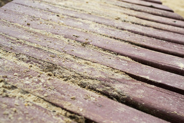 Sand on planked wood. Autumn background with copy space.