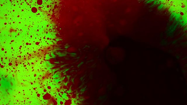 Analysis of blood tests on green screen. Green and red ink reacting on surface. Video depicting bloody stains, spreading disease, research using a scientific microscope at magnification. Paint bloom.