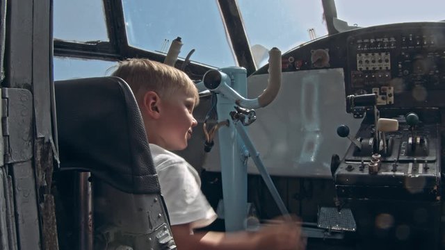 Small kid on the cabin of an airplane