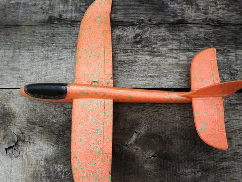 Orange Plane On Wooden Background