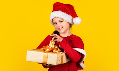 Be happy. gift brings joy and happiness. happy new year. merry christmas. xmas joy mood. small santa kid yellow background. little girl present box. winter holiday shopping. time for presents