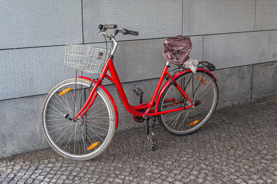 Red Bicycle against a concrete wall
