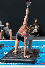 Girl Doing Exercises on Floating Fitness Mat in an Outdoor Swimming Pool