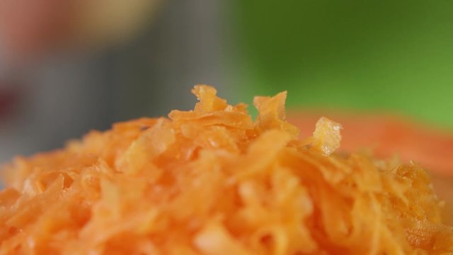 freshly grated carrot crumbs falling, close up