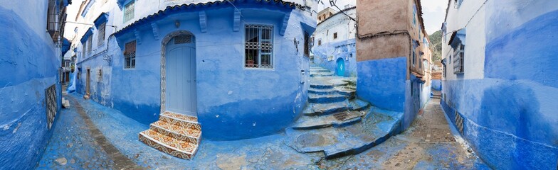 Traditional typical moroccan architectural details in Chefchaouen, Morocco, Africa Beautiful street of blue medina with blue walls and decorated with various objects (pots, jugs). A city with narrow, 