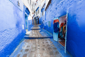 Traditional typical moroccan architectural details in Chefchaouen, Morocco, Africa Beautiful street of blue medina with blue walls and decorated with various objects (pots, jugs). A city with narrow, 