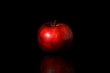 Fototapeta na wymiar whole red apple on a black background