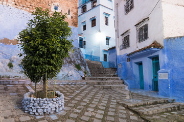 Traditional typical moroccan architectural details in Chefchaouen, Morocco, Africa Beautiful street of blue medina with blue walls and decorated with various objects (pots, jugs). A city with narrow, 