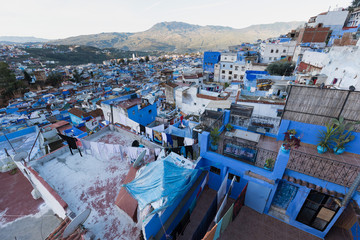 Traditional typical moroccan architectural details in Chefchaouen, Morocco, Africa Beautiful street of blue medina with blue walls and decorated with various objects (pots, jugs). A city with narrow, 